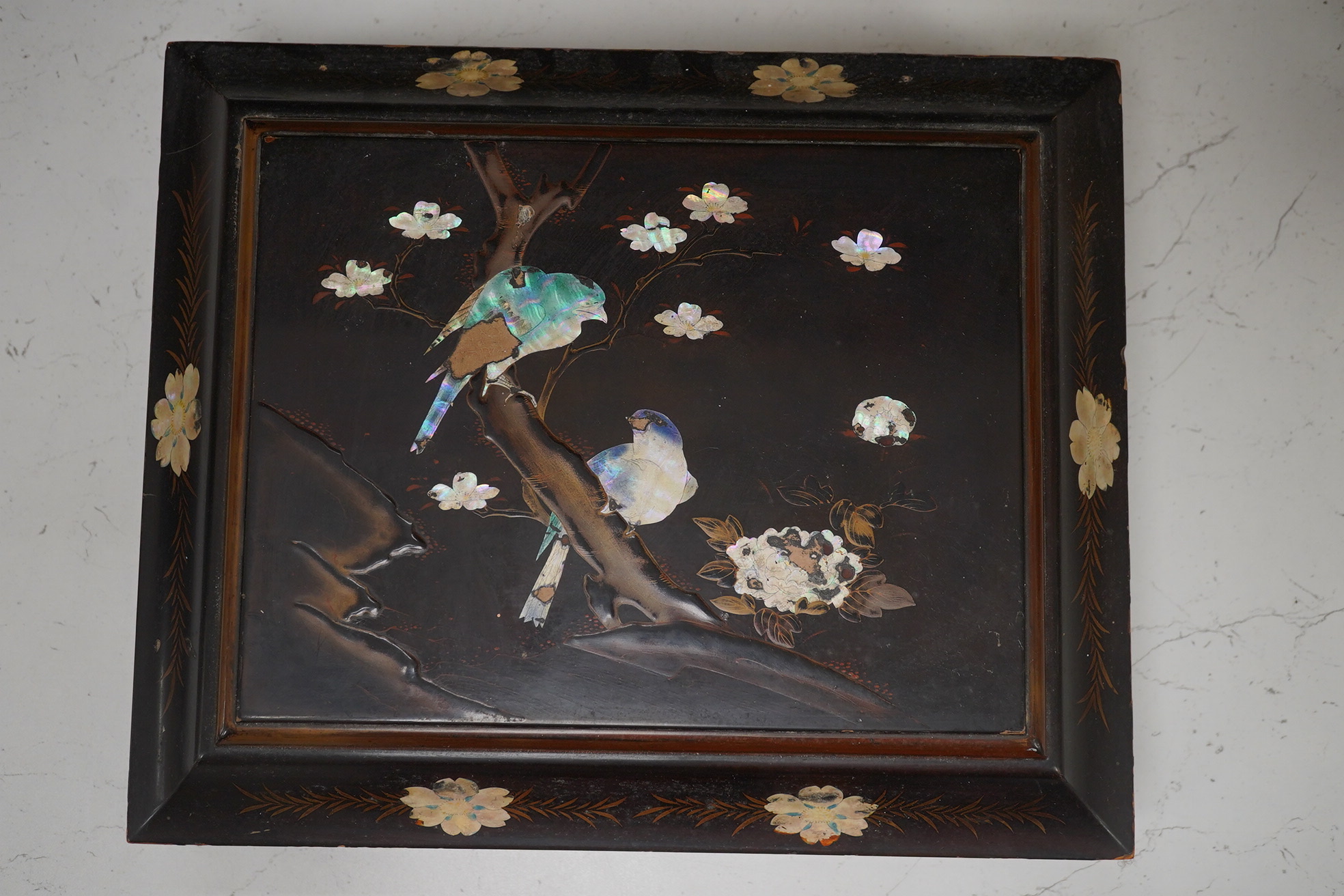 A Japanese lacquered box with mother of pearl inlay of birds and flowers, 35.5cm wide. Condition - worn on the outside to be expected, inside good